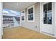 Exterior view of a covered porch with wood decking, white railings, and windows that provide ample light at 190 Steepbrook, Summerville, SC 29486