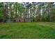 Large backyard with detached workshop, chicken coop and playhouse; all surrounded by mature trees at 202 Woodland Dr, Summerville, SC 29485