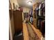 Walk-in closet offers hanging storage, open shelving, and ample room to store a collection of clothing and ties at 202 Woodland Dr, Summerville, SC 29485