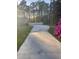 Concrete driveway leading to a house with a white fence at 202 Woodland Dr, Summerville, SC 29485