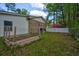 Home exterior featuring brick accents, white siding, and an empty raised garden in the landscaped backyard at 202 Woodland Dr, Summerville, SC 29485