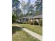 Charming single-story home featuring well-maintained landscaping, beautiful flowers, and mature trees at 202 Woodland Dr, Summerville, SC 29485