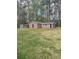 Exterior of a house with a green lawn and surrounded by trees at 202 Woodland Dr, Summerville, SC 29485