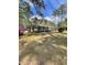 Traditional style home with a well-manicured lawn and mature trees at 202 Woodland Dr, Summerville, SC 29485