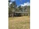 Exterior of a home with a large front yard and mature trees at 202 Woodland Dr, Summerville, SC 29485