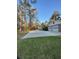 Spacious driveway leading to a two-car garage, set against a backdrop of tall trees at 202 Woodland Dr, Summerville, SC 29485