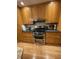 Traditional kitchen with wood cabinets, stainless steel stove, and light wood floor at 202 Woodland Dr, Summerville, SC 29485
