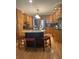 Modern kitchen with stainless steel appliances, a center island with barstool seating, and hardwood flooring at 202 Woodland Dr, Summerville, SC 29485