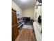 Functional laundry room with modern washer and dryer, ample shelving, and an ironing board at 202 Woodland Dr, Summerville, SC 29485