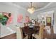 Dining room with decorative trey ceiling, dark wood table, and views to the yard at 205 Fairchild St, Daniel Island, SC 29492