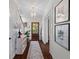 Bright entryway with hardwood floors, elegant lighting, and a decorative rug leading to a wood door at 205 Fairchild St, Daniel Island, SC 29492