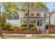 Charming two-story home with light blue exterior, colorful shutters, and inviting front porch landscaping at 205 Fairchild St, Daniel Island, SC 29492