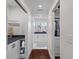 Hallway leading to a bathroom with dark countertops and a walk-in closet at 205 Fairchild St, Daniel Island, SC 29492