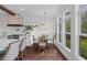 Eat-in kitchen area with hardwood floors, stainless steel appliances, and views of the backyard at 205 Fairchild St, Daniel Island, SC 29492