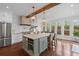 Open kitchen boasts a center island, stainless appliances, and ample natural light from the surrounding windows at 205 Fairchild St, Daniel Island, SC 29492