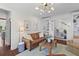 Bright living room with hardwood floors, neutral walls, and comfortable leather furniture at 205 Fairchild St, Daniel Island, SC 29492