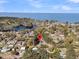 Aerial view of a waterfront community surrounded by lush trees and sparkling waters at 212 Lake Moultrie Dr, Bonneau, SC 29431