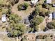 Aerial view showcasing home's placement with the lot and surroundings on a sunny day with a blue sky at 212 Lake Moultrie Dr, Bonneau, SC 29431
