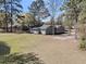 An aerial view of a single Gathering home and large yard surrounded by mature trees at 212 Lake Moultrie Dr, Bonneau, SC 29431