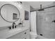 Bathroom vanity with black faucet and modern marble-tiled shower at 212 Lake Moultrie Dr, Bonneau, SC 29431