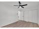 Bright bedroom featuring a ceiling fan, natural light, and light colored laminate flooring at 212 Lake Moultrie Dr, Bonneau, SC 29431