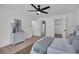 Bedroom with ceiling fan, light floors, and ensuite bath and closet at 212 Lake Moultrie Dr, Bonneau, SC 29431