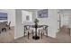Cozy breakfast nook with a black table, two chairs, and view into the living room at 212 Lake Moultrie Dr, Bonneau, SC 29431