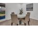 Dining area featuring a round table with seating for four, modern decor, and wood flooring at 212 Lake Moultrie Dr, Bonneau, SC 29431