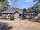 Exterior view of home showing a dark gray roof and black chimney surrounded by mature trees at 212 Lake Moultrie Dr, Bonneau, SC 29431