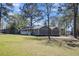 Traditional style home with a well-manicured lawn and mature trees at 212 Lake Moultrie Dr, Bonneau, SC 29431