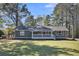 Charming one story home with white picket fence porch and natural landscaping at 212 Lake Moultrie Dr, Bonneau, SC 29431