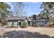 Charming one story home with mature landscaping, a brick chimney and a side entry at 212 Lake Moultrie Dr, Bonneau, SC 29431