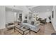 Bright and airy living room with white sofa, glass coffee table, and view into the dining area at 212 Lake Moultrie Dr, Bonneau, SC 29431