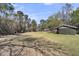 Expansive lot with large trees and a green outbuilding, offering plenty of space and potential at 212 Lake Moultrie Dr, Bonneau, SC 29431