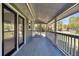 Relaxing covered porch great for entertaining with serene outdoor views at 212 Lake Moultrie Dr, Bonneau, SC 29431