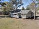 An aerial view of a one story home with a white picket fence porch and natural landscaping at 212 Lake Moultrie Dr, Bonneau, SC 29431