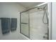 Close-up of the bathroom shower showing a sliding glass door and gray towels on the wall at 219 Tuscany Ct, Ladson, SC 29456