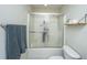 Bathroom featuring a tub with shower, sliding door, and wall accessories displaying a functional space at 219 Tuscany Ct, Ladson, SC 29456