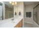 Bright bathroom featuring a large mirror, vanity with cabinets, and a shower with glass doors at 219 Tuscany Ct, Ladson, SC 29456