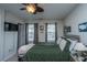 Inviting bedroom showcasing a comfortable bed, television, and windows dressed with elegant gray curtains at 219 Tuscany Ct, Ladson, SC 29456