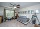 Bedroom with a daybed, large window, ceiling fan, and assorted decor showcasing a comfortable living space at 219 Tuscany Ct, Ladson, SC 29456