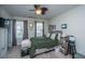 Cozy bedroom featuring a ceiling fan, natural light from two windows, and a stylish wooden headboard at 219 Tuscany Ct, Ladson, SC 29456