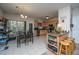 Open-concept dining area with a bar, kitchen, and large windows that let in lots of light at 219 Tuscany Ct, Ladson, SC 29456