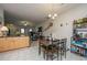 Bright dining area featuring a stylish light fixture, a table with seating for four, and views into the living space at 219 Tuscany Ct, Ladson, SC 29456