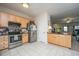 Well-lit kitchen features light wood cabinetry, stainless steel appliances, and a tile backsplash for a modern look at 219 Tuscany Ct, Ladson, SC 29456