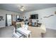 Bright living room with neutral carpet, couch, and ample space for various activities at 219 Tuscany Ct, Ladson, SC 29456