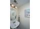 Modest powder room features a round mirror, a sink, a vintage-style vanity light, and artwork at 219 Tuscany Ct, Ladson, SC 29456