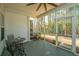 Relaxing screened-in porch with outdoor seating, ceiling fan, and serene wooded views at 219 Tuscany Ct, Ladson, SC 29456