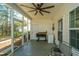 Inviting screened porch with ceiling fan, grilling area, and scenic backyard access at 219 Tuscany Ct, Ladson, SC 29456