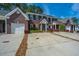 Desirable brick townhouses with convenient driveway parking and manicured shrubbery at 219 Tuscany Ct, Ladson, SC 29456
